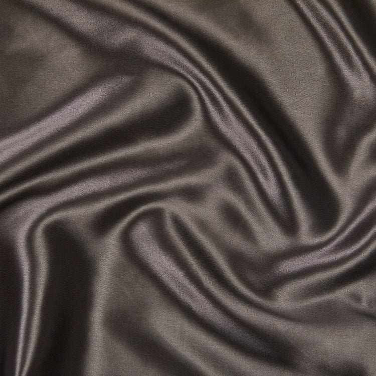 A close up of KAILU's luxurious silk pillowcase fabric in charcoal, made with the highest-quality, OEKO-TEX-certified mulberry silk in 22 momme silk weight
