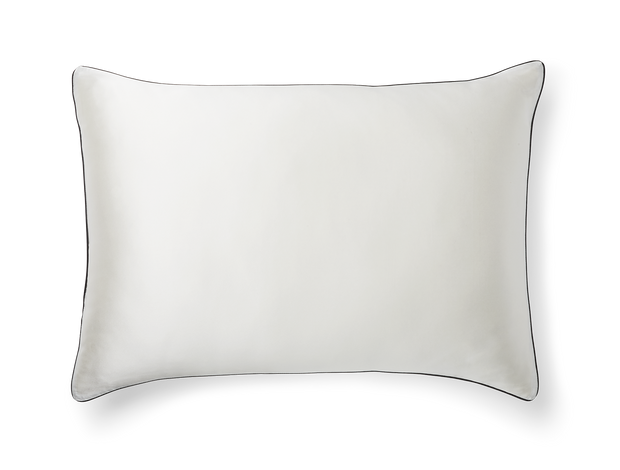 A KAILU silk pillowcase in white with black piping, made with the highest-quality, OEKO-TEX-certified mulberry silk in 25 momme silk weight
