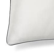 A close up of the piping detail of a KAILU silk pillowcase in white with black piping, made with the highest-quality, OEKO-TEX-certified mulberry silk in 25 momme silk weight